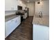 Modern kitchen with stainless steel appliances, granite countertops, and white cabinetry at 1109 Sunrise Dr, Lochbuie, CO 80603