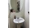 Bathroom with pedestal sink and modern fixtures at 1109 Sunrise Dr, Lochbuie, CO 80603