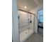 Modern shower with glass door and white tile, offering a clean and bright space at 1109 Sunrise Dr, Lochbuie, CO 80603