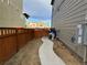 Narrow side yard featuring a walkway and utilities at 1109 Sunrise Dr, Lochbuie, CO 80603