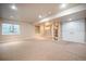 Spacious basement with neutral carpet, recessed lighting, built in shelves and window for natural light at 2550 Winding River Dr # E1, Broomfield, CO 80023
