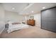 Finished basement bedroom with large wardrobe, carpet, recessed lights and side tables at 2550 Winding River Dr # E1, Broomfield, CO 80023