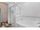 Clean bathroom featuring a glass-enclosed shower over tub combination and wood-style vinyl flooring at 2550 Winding River Dr # E1, Broomfield, CO 80023