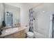 Functional bathroom features a tub with shower, single vanity, and essential amenities in a well-maintained space at 2550 Winding River Dr # E1, Broomfield, CO 80023