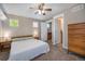 Relaxing bedroom with a cozy bed, soft lighting, and easy access to an en-suite bathroom at 2550 Winding River Dr # E1, Broomfield, CO 80023