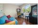 Cozy bedroom with hardwood floors and a window at 2550 Winding River Dr # E1, Broomfield, CO 80023