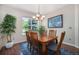 Bright dining room with large window, chandelier, and seating for six at 2550 Winding River Dr # E1, Broomfield, CO 80023
