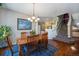 Bright dining room with large window, chandelier, and seating for six at 2550 Winding River Dr # E1, Broomfield, CO 80023
