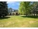 Landscaped front lawn and exterior of gray two-story home with covered porch at 2550 Winding River Dr # E1, Broomfield, CO 80023