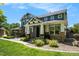 Charming two-story home with a covered porch, stone accents, and beautifully landscaped front yard at 2550 Winding River Dr # E1, Broomfield, CO 80023