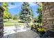 Covered front porch with seating area and lush green lawn at 2550 Winding River Dr # E1, Broomfield, CO 80023