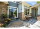 Covered porch with stone accents, a seating area and a sliding glass door for entry at 2550 Winding River Dr # E1, Broomfield, CO 80023