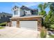 Attached two-car garage with brick facade at 2550 Winding River Dr # E1, Broomfield, CO 80023