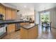 Bright kitchen with stainless steel appliances, island and granite countertops, perfect for cooking and entertaining at 2550 Winding River Dr # E1, Broomfield, CO 80023
