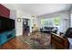 Bright living room with large windows, hardwood floors, and stylish furniture at 2550 Winding River Dr # E1, Broomfield, CO 80023