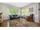 Bright living room with large windows, hardwood floors, and stylish furniture at 2550 Winding River Dr # E1, Broomfield, CO 80023