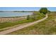 Picturesque view of a serene walking path along a tranquil lake at 2550 Winding River Dr # E1, Broomfield, CO 80023