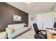 Well-lit bedroom featuring a cozy couch, neutral carpet and a contrasting accent wall at 2841 N Columbine St, Denver, CO 80205