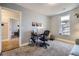 Bright bedroom with a desk, office chair, a large window, and neutral colored walls and carpet at 2841 N Columbine St, Denver, CO 80205