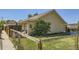 Exterior showcasing the fenced yard, landscaping, and charming architecture of the home at 2841 N Columbine St, Denver, CO 80205