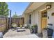 Charming front yard with stylish outdoor seating, decorative plants, and a wooden front door at 2841 N Columbine St, Denver, CO 80205