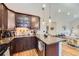 A modern kitchen features granite countertops, stainless steel appliances, and wooden cabinets at 2841 N Columbine St, Denver, CO 80205