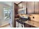 Kitchen with stainless steel appliances, granite countertops, and dark wooden cabinets at 2841 N Columbine St, Denver, CO 80205