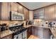 Close-up view of kitchen featuring granite countertops, tiled backsplash, and stainless steel appliances at 2841 N Columbine St, Denver, CO 80205