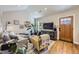 Well-lit living room with an entertainment center, hardwood floors, and open access to other living areas at 2841 N Columbine St, Denver, CO 80205