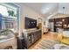 Open-concept living space flows from the kitchen with hardwood floors and large windows, bathed in natural light at 2841 N Columbine St, Denver, CO 80205