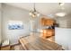 Sunlit dining area featuring a rustic table with seating and views of the kitchen at 9335 Amison Cir # 203, Parker, CO 80134