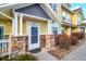 Welcoming entryway with charming stone accents and bright yellow siding, leading to a cozy home at 9335 Amison Cir # 203, Parker, CO 80134