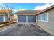 Attached two-car garage with a paved driveway, set in a well-maintained neighborhood at 9335 Amison Cir # 203, Parker, CO 80134