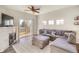 Spacious living room with a fireplace, plush sectional sofa, and access to a private balcony at 9335 Amison Cir # 203, Parker, CO 80134