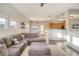 Bright, open-concept living area featuring a comfortable sectional sofa and adjacent dining space at 9335 Amison Cir # 203, Parker, CO 80134