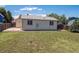 Grassy backyard with partial privacy fence and rear view of home's exterior at 1718 S Flanders Way, Aurora, CO 80017