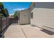 View of backyard featuring concrete patio, partial privacy fence, and exterior of home at 1718 S Flanders Way, Aurora, CO 80017