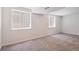Unfinished basement space with large windows and neutral carpeting at 1718 S Flanders Way, Aurora, CO 80017