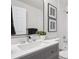 Modern bathroom with gray vanity, white countertop, and updated fixtures at 1718 S Flanders Way, Aurora, CO 80017