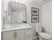 Bright bathroom featuring a large mirror, white vanity with drawers, and neutral decor at 1718 S Flanders Way, Aurora, CO 80017