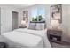 Comfortable bedroom with a stylish bed, neutral colors, and a large window at 1718 S Flanders Way, Aurora, CO 80017