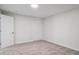Bright bedroom featuring neutral carpet, white walls, and a large closet at 1718 S Flanders Way, Aurora, CO 80017