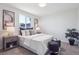 Bright bedroom with a comfortable bed, stylish decor, and a large window at 1718 S Flanders Way, Aurora, CO 80017