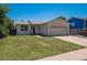 Charming single-story home with a well-manicured lawn and attached two car garage at 1718 S Flanders Way, Aurora, CO 80017