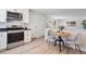 Well-lit kitchen with stainless steel appliances and a dining table with chairs at 1718 S Flanders Way, Aurora, CO 80017