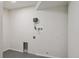 Laundry room with plumbing hookups, painted floors, and white walls at 1718 S Flanders Way, Aurora, CO 80017