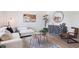 Stylish living room featuring hardwood floors, a modern sofa, and neutral decor at 1718 S Flanders Way, Aurora, CO 80017