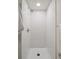 Newly tiled shower with white subway tiles and a modern showerhead at 1718 S Flanders Way, Aurora, CO 80017