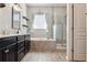 Modern bathroom with soaking tub, walk-in shower, and dark wood cabinets at 20150 E Fair Ln, Centennial, CO 80016