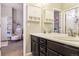 Shared bathroom with double sinks and dark cabinetry at 20150 E Fair Ln, Centennial, CO 80016